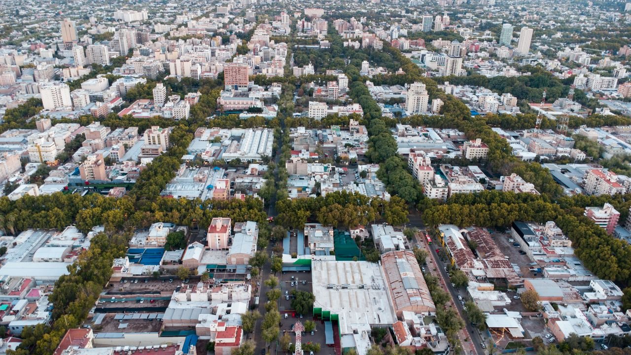 Home Drone shot capturing the vibrant urban layout and greenery of Mendoza City, Argentina.